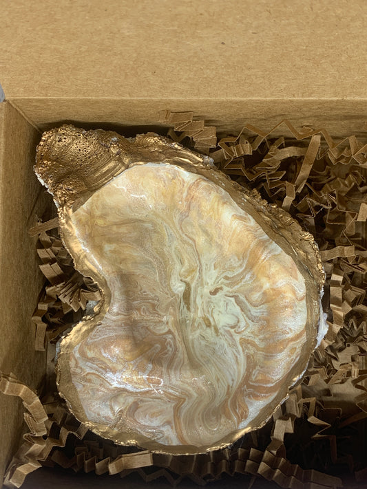 Paint pour in browns, gold, and white jewelry dish